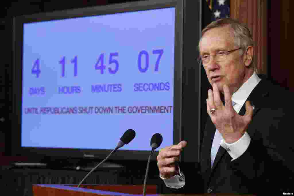 U.S. Senate Majority Leader Harry Reid discusses the potential government shutdown, while standing in front of a countdown clock, on Capitol Hill in Washington, D.C. Reid, a Democrat, rejected plans by Republicans in the House of Representatives to advance a debt limit increase bill that contains measures such as delaying "Obamacare."