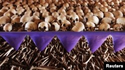 FILE - Skulls and bones of Rwandan victims rest on shelves at a genocide memorial inside a church at Ntarama, near the capital Kigali, Aug. 6, 2010.