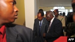 Somalia's newly elected President Hassan Sheikh Mohamud (C) and Kenya's Foreign Affairs Minister Sam Ongeri (2nd R) leave the Jazeera hotel after a bomb blast outside the venue in Mogadishu, September 12, 2012.