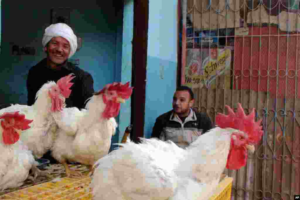 Shopkeepers in Mit Rahina, a village taking part in this week's elections. (VOA-E.Arrott)