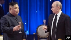 Russian President Vladimir Putin, right, toasts with North Korea's leader Kim Jong Un after their talks in Vladivostok, Russia, April 25, 2019.