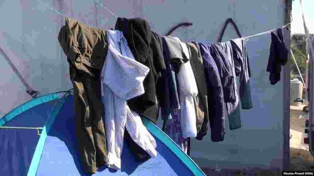 Des vêtements suspendus dans la "jungle". Ce camp est situé aux abords de Calais dans le nord de la France, 13 octobre 2015 (Nicolas Pinault/VOA). 