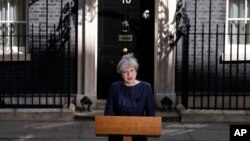 FILE - Britain's Prime Minister Theresa May speaks to the media outside her official residence of 10 Downing Street in London, April 18, 2017. 