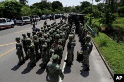 Military police form on the highway, in Metapa, Chiapas state, Mexico, June 5, 2019. A law enforcement group of police officers, marines, military police and immigration officials arrived at the area to intercept a caravan of migrants that had earlier crossed the Mexico-Guatemala border.
