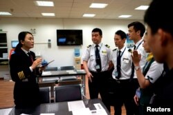 Captain Han Siyuan, 30, gets ready before her plane takes off at an office of Spring Airlines in Shanghai, China, Oct. 18, 2018.