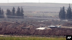 Turkish forces artillery pieces are seen on their new positions near the border with Syria in Sanliurfa province, Turkey. U.S.-backed Kurdish-led forces in Syria said American troops began withdrawing Monday from their positions, Oct. 6, 2019.