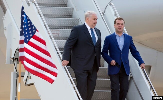 FILE - Russian Prime Minister Dmitry Medvedev, right, walks with Sergey Kislyak, Russian ambassador to the U.S., as he arrives for the G8 Summit at Dulles International Airport in Chantilly, Va., May 18, 2012.