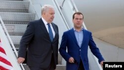 FILE - Russian Prime Minister Dmitry Medvedev, right, walks with Sergey Kislyak, Russian ambassador to the U.S., as he arrives for the G8 Summit at Dulles International Airport in Chantilly, Va., May 18, 2012. 