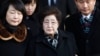 FILE - Lee Hee-ho, center, the wife of the late former South Korean President Kim Dae-jung, arrives at the Inter-Korean Transit Office from North Korea at the border village of Paju in the demilitarized zone, South Korea, Dec. 27, 2011. 