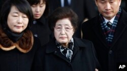 FILE - Lee Hee-ho, center, the wife of the late former South Korean President Kim Dae-jung, arrives at the Inter-Korean Transit Office from North Korea at the border village of Paju in the demilitarized zone, South Korea, Dec. 27, 2011. 