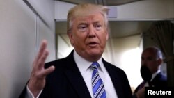 FILE - President Donald Trump talks to reporters aboard Air Force One at Joint Base Andrews outside Washington, U.S., May 13, 2017. He spoke for an hour with journalists aboard the plane as it headed to France.