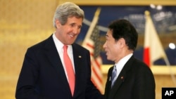 U.S. Secretary of Sate John Kerry, left, is greeted by Japanese Foreign Minister Fumio Kishida prior to their meeting at Foreign Ministry's Iikura Guesthouse in Tokyo, April 14, 2013. 