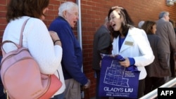 FILE - Liberal Party candidate Gladys Liu (R) speaks with early voters in the May 18 election for the outer Melbourne electorate of Chisholm, in Melbourne, Australia, May 7, 2019.