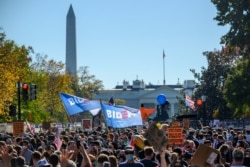 People celebrate on Black Lives Matter Plaza across from the White House in Washington, Nov. 7, 2020, after Democrat Joe Biden was projected the winner of the 2020 presidential election.