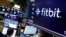 The logo for FItbit appears above a trading post on the floor of the New York Stock Exchange, Oct. 28, 2019. 