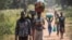 A South Sudanese refugee family walks toward a refugee camp in Aba, Democratic of Congo, after crossing from South Sudan to escape fighting. (J. Patinkin for VOA)