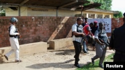 Security officers patrol the Kano State Polytechnic campus in northern Nigeria, where a female suicide bomber blew herself up, July 30, 2014.