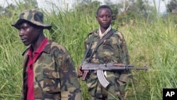 Fighters of the rebel Union of Congolese Patriots, one of them a child soldier, man a checkpoint, on the outskirts of Bunia, Congo, (File)