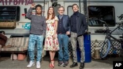 FILE - Tye Sheridan, from right, Steven Spielberg, Oliva Cooke, and Lena Waithe pose at the interactive "Ready Player One" pop-up on Hollywood and Vine in Los Angeles, March 16, 2018.