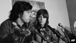 FILE - Tom Hayden talks as Jane Fonda listens at a news conference at the New York offices of the Center for Constitutional Rights, Jan. 2, 1973.