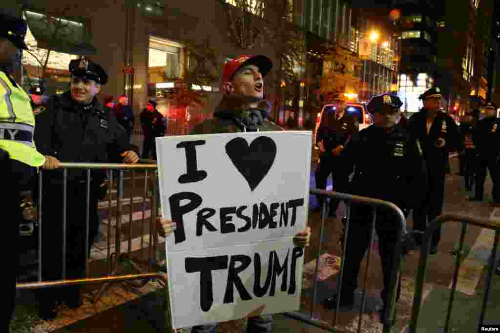 A supporter of President-elect Donald Trump shouts back at opposing demonstrators during a protest against the president-elect in Manhattan, New York, Nov. 11, 2016.