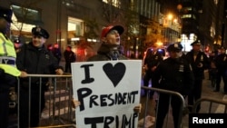 A supporter of President-elect Donald Trump shouts back at opposing demonstrators during a protest against the president-elect in Manhattan, New York, Nov. 11, 2016.