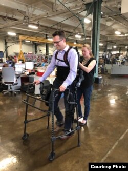 Patrick Wensing tests out an Ekso Bionics exoskeleton in his lab at the University of Notre Dame. He and his team are working to make the machines more intuitive. (Photo: Notre Dame)