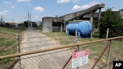 A gate at the U.S. Oil Recovery Superfund site, Sept. 14, 2017, in Pasadena, Texas, where three tanks once used to store toxic waste were flooded during Hurricane Harvey.