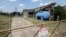 A gate at the U.S. Oil Recovery Superfund site, Sept. 14, 2017, in Pasadena, Texas, where three tanks once used to store toxic waste were flooded during Hurricane Harvey.
