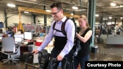 Patrick Wensing tests out an Ekso Bionics exoskeleton in his lab at the University of Notre Dame. He and his team are working to make the machines more intuitive. (Photo: Notre Dame)