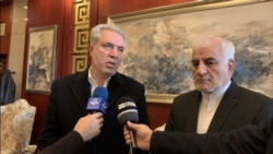 Iranian Tourism Minister Ali Asghar Mounesan, left, speaks to reporters on a visit to Beijing in November 2019, as Iranian Ambassador to China Mohammad Keshavarz-Zadeh looks on. (Credit: IRNA)