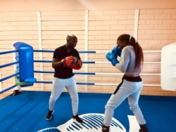 Sadie Keamogetse Kenosi sparring with her coach, Lechedzani 'Master' Luza. (VOA/Mqondisi Dube).