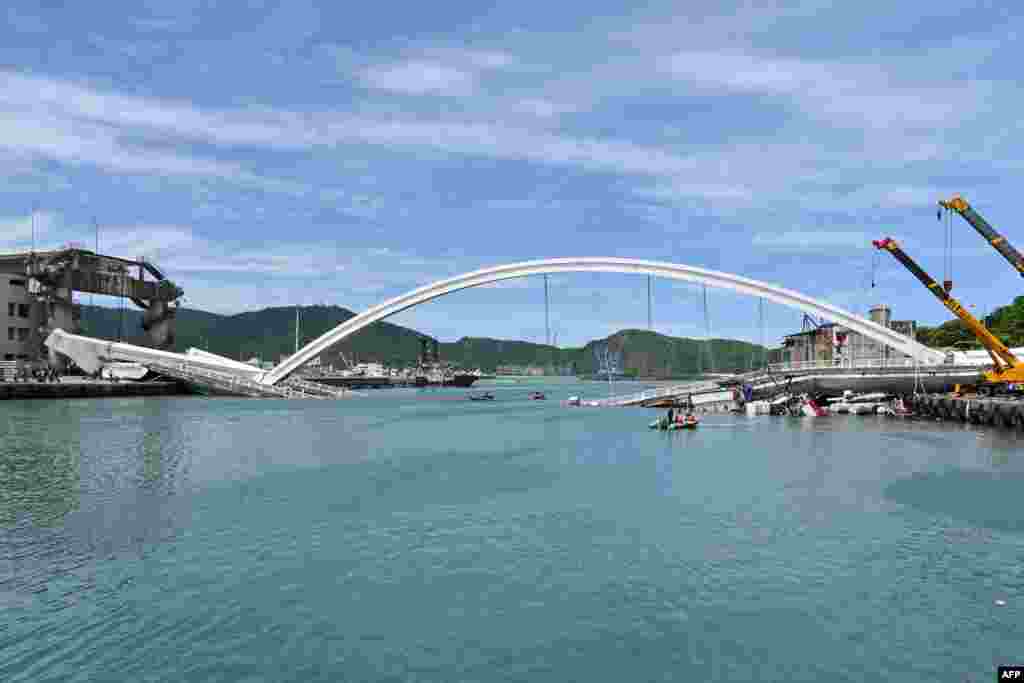 This general view shows a bridge after it collapsed in the Nanfangao fish harbor in Suao township, in northeastern Taiwan. At least 14 people were injured when the bridge smashed down onto fishing vessels moored underneath and sent a petrol tanker plummeting into the water.