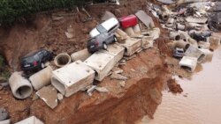 Debris of the sewage system and damaged cars are pictures in the Blessem district of Erftstadt, Germany, Friday, July 16, 2021.