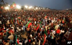 Supporters of the opposition Pakistan Tehreek-e-Insaf party wave party flags while taking part in a rally in Islamabad, Pakistan, Nov. 2, 2016.