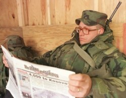 FILE - U.S. soldier Sgt. John Hubbuch of Versailles, Kentucky, a member of the NATO-led peacekeeping forces in Bosnia, reads Stars and Stripes newspaper at a U.S. air base near Tuzla, Feb. 14, 1999.