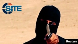 FILE - "Jihadi John," a militant who has been identified by the Washington Post newspaper as a Briton named Mohammed Emwazi, brandishes a knife in this still image from a 2014 video obtained from SITE Intel Group.