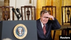 FILE - Former U.S. President George H.W. Bush looks into the audience during the Medal of Freedom ceremony at the White House in Washington February 15, 2011. 