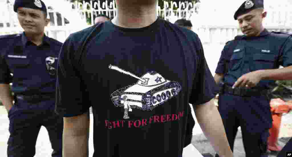 A protester wears a T-shirt with a tank during a protest in front of the Chinese Embassy in Kuala Lumpur, June 4, 2014. 