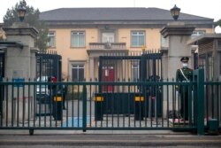 FILE - A Chinese officer stands outside the British Embassy in Beijing, March 26, 2021. Days earlier, China sanctioned British entities following the U.K.'s joining the EU and others in sanctioning Chinese officials over alleged rights abuses.