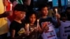 Palestinian children light candles to show their solidarity with the Lebanese people following the explosion in the port of Beirut, at the unknown soldier square in Gaza City, Aug. 6, 2020.