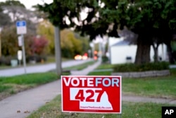 FILE - A yard sign promoting Initiative 427, the Medicaid Expansion Initiative, is seen in Omaha, Neb., Oct. 17, 2018. For nearly a decade, opposition to Obama's health care law has been a winning message for Nebraska Republicans, helping them take every statewide office, dominate the Legislature and hold all of the state's congressional seats.