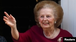 Former British Prime Minister Margaret Thatcher waves from her front doorstep. (File)