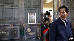 File Photo shows Lin Zuluan, a representative from the village of Wukan in Lufeng county, Guangdong province, followed by members of the international media as he leaves his home, December 21, 2011