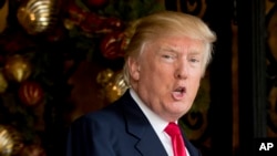 FILE - President-elect Donald Trump speaks to members of the media at Mar-a-Lago, in Palm Beach, Fla.