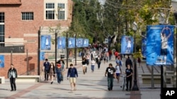 FILE - Students make their way across the UCLA campus in Los Angeles, Feb. 26, 2015. The Department of Homeland Security begins collecting “social media handles, aliases, associated identifiable information and search results” from all immigrants seeking to enter the U.S.