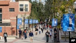 FILE - Students make their way across the UCLA campus in Los Angeles, Feb. 26, 2015. University of California officials have proposed limiting nonresident enrollment all undergraduate students, in an effort to prioritize in-state applicants.