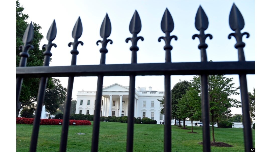 The White House is framed with the fence on the North side of the White House in Washington, Sept. 20, 2014.