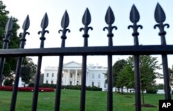 The White House is framed with the fence on the North side of the White House in Washington, Sept. 20, 2014.