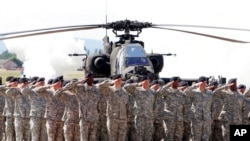 FILE - Soldiers attend a color casing ceremony of the First Armored Division at the U.S. Army Airfield in Wiesbaden, Germany, May 13, 2011.